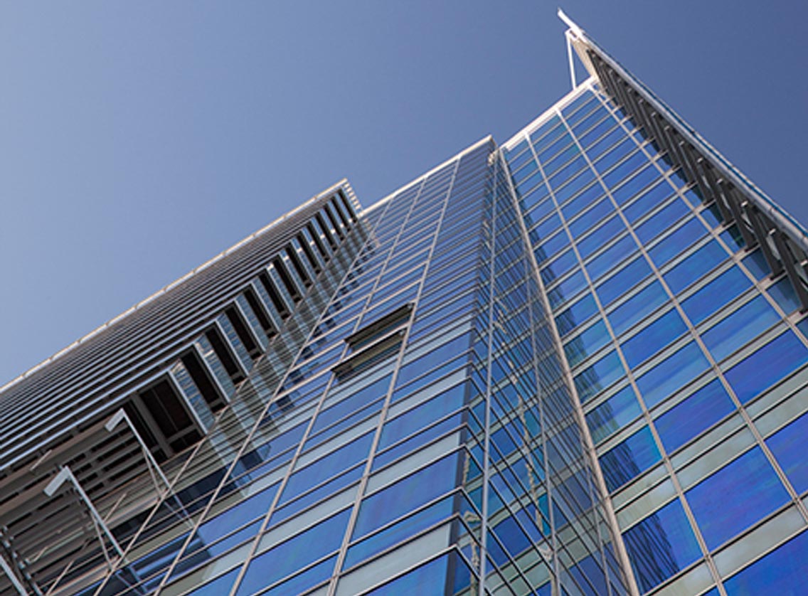 Sloping 23 storey glass wall and mast in Aldgate